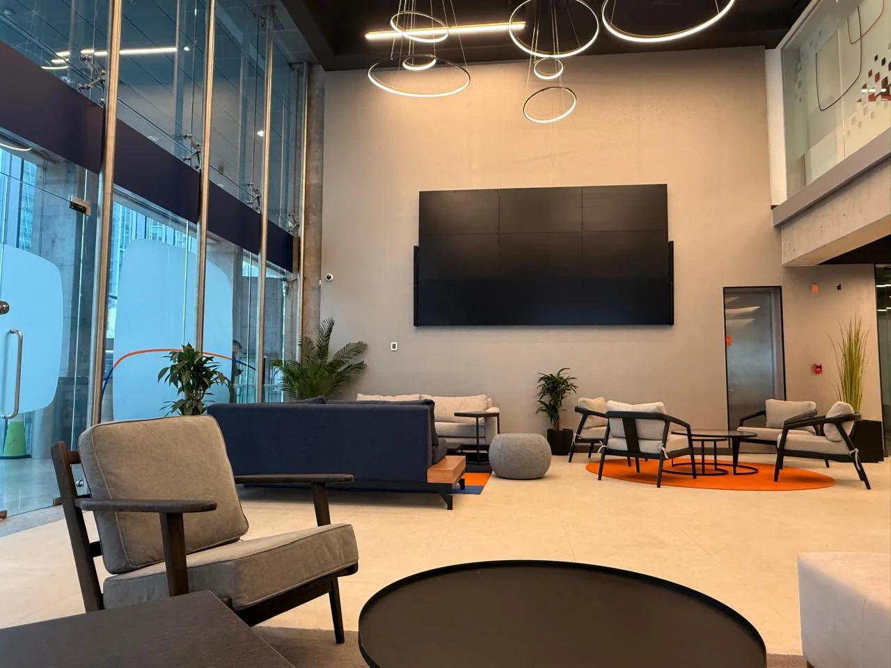 Espacio corporativo con mobiliario de oficina, mamparas de vidrio y áreas de encuentro